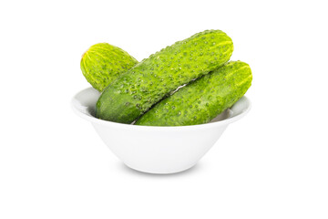 Three fresh green cucumbers in white bowl isolated on white background