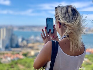 woman taking photo with mobile phone