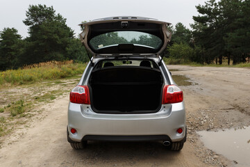 Obraz na płótnie Canvas Silver color car with an open trunk