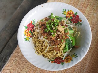muara karang, north jakarta - indonesia / april 3rd 2019 : the common noodle can easily found at the street seller, consist of vegetable, bean sprouts, meat consist of mixed chicken and mushroom