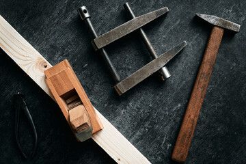 Old woodworking tools on dark background, top view