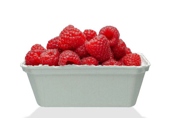 ripe raspberries in a paper box isolated on a white background