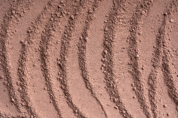 Background or backdrop of brown sweet cocoa powder texture with lines pattern made from dried beans used in drink preparation, also in bakery and culinary contains flavonoids. Horizontal, copy space