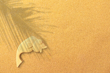 Fototapeta na wymiar Fish sand sclupture on a holiday beach made out of beachsand.