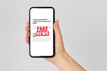 Fake news concept reading news media technology on smartphone just Fake - obrazy, fototapety, plakaty