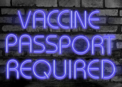 purple neon city sign for vaccine passport requirement glowing on dark brick wall