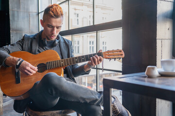 Portrait of male musician playing the guitar