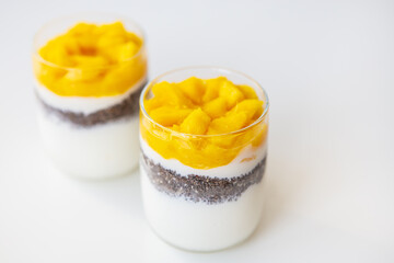 Delicious mango dessert with yogurt and chia seeds. The concept of healthy and tasty food. Good...