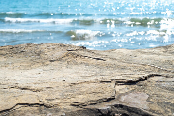 Empty cliff stone with summer blue sea blur background. Copy space for display of product on online media