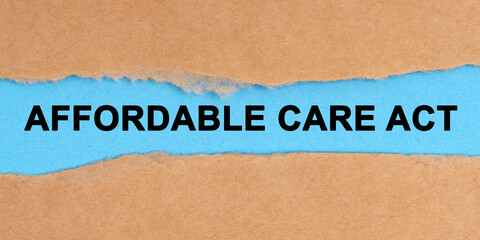 The paper is ripped in the middle. Inside on a blue background it is written - affordable care act