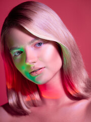Naklejka premium Portrait with neon-style lighting, a young beautiful blonde