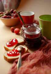 Still life with fresh strawberry in a bowl, strawberry jam and bread for breakfast