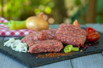 Cevapi - minced meat with spices ready for the grill. Traditional Balkan food..