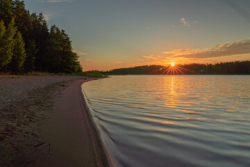 Early sunrise at sea. Reflected sun rays on sea water. Glare on the water Natural sea water...