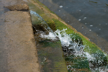 water flowing over a stepped weir into the river below