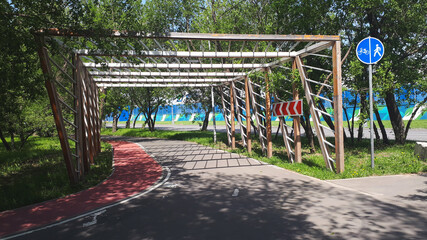 Fototapeta premium Cycle Lane-bike Path With A Wooden Fence With Signs, In Summer, Afternoon