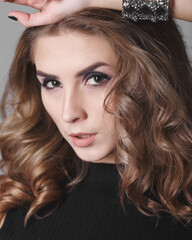 Obraz premium Fashion portrait. Studio photo on a gray background. Young pretty model.