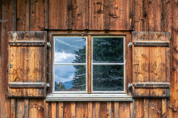 Fenster eines rustikalen Bauernhauses mit hölzernen Fensterläden