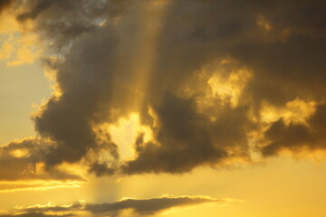 Fototapeta na wymiar Beautiful sunset with dark clouds and sunbeam