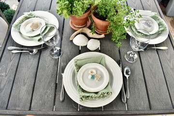 Summer outdoor backyard or cafe dining table setting with seasonal decor for romantic fresh al...