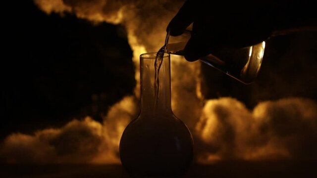 Pharmacy and chemistry theme. Test glass flask with solution in research laboratory. Science and medical background. Laboratory test tubes on abstract explosion cloud background. Selective focus