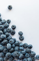 Handful of ripe blueberries isolated on white background, top view.