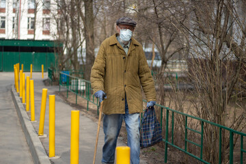 An old man in Russia. A man with a walking stick.