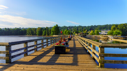 Wooden pier with planters by boat launch ramp into Burrard Inlet, BC