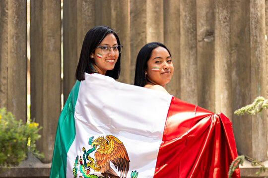 Two Mexican Women With The Flag Of Mexico