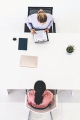 Two young business women in meeting at office table for job application and business agreement....