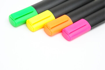 Multicolored markers on white background