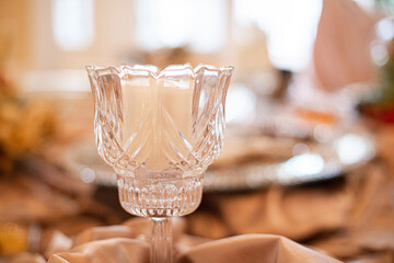 Glass decorative candle stick holder centerpiece on table at wedding reception