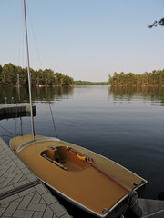 Yellow sailboat on a lake 