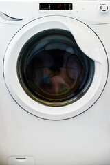 Front view of a white washing machine with number one on the display