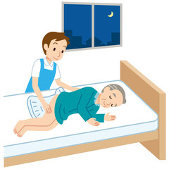 夜間のオムツ交換をするヘルパー　高齢者　介護
