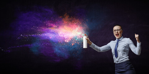 Businesswoman spraying paint . Mixed media