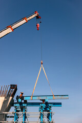 Fototapeta na wymiar Industrial Crane lifting steel frame in construction site