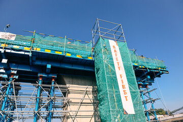 A Building Under Construction with safety first banner