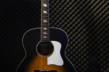 Obraz na płótnie Canvas Acoustic guitar standing in the recording studio