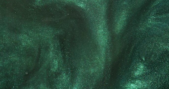 The dark glittering water slowly flows into beautiful abstract patterns