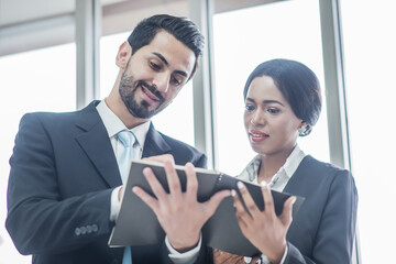 secretary presents  document to boss or manager to sign