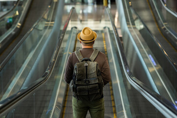 Traveler man wearing mask protect flu coronavirus. Tourist in airport terminal standing at...