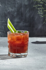 Red Bloody Mary Cocktail is a low-alcohol cocktail with vodka and tomato juice. Vintage table with...