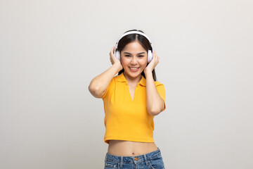 Cheerful asian female teenager listen to the music with white headphone on isolated. Beautiful...