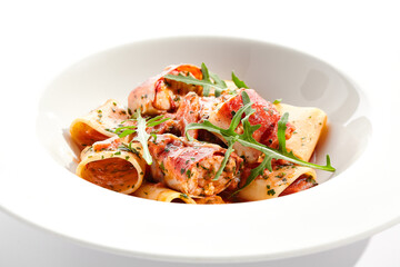 Tuna Cannelloni pasta - noodles plate with tuna fish meat. Pasta dish with tuna, tomato sauce and rocket salad. Restaurant gourmet cannelloni pasta food plate isolated on white background..