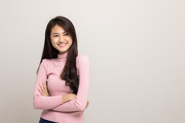 Beautiful asian woman look into blank space. Smiling female wearing pink shirt on isolated white background. Attractive Teenager girl looking at empty space for text feeling excited and surprised.