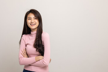 Beautiful asian woman look into blank space. Smiling female wearing pink shirt on isolated white background. Attractive Teenager girl looking at empty space for text feeling excited and surprised.