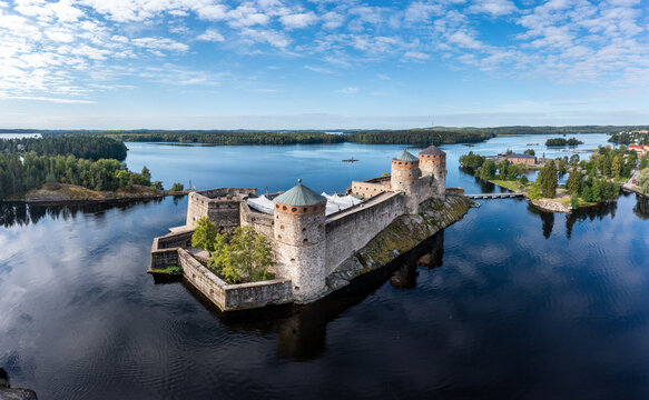 Aerial panorama of Olavinlinna castle and the surrounding lakes in Savonlinna, Finland.