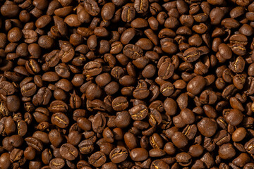Roasted coffee beans closeup Background, Coffee grains scattered on the table, working hours coffee, hot drinks.