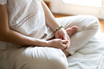 senior woman doing meditation at home. mindfulness concept